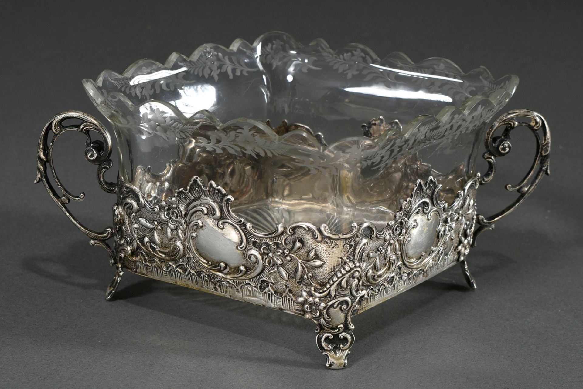 A rhombus-shaped biscuit dish in neo-rococo style on small feet with ornamental handles and floral 