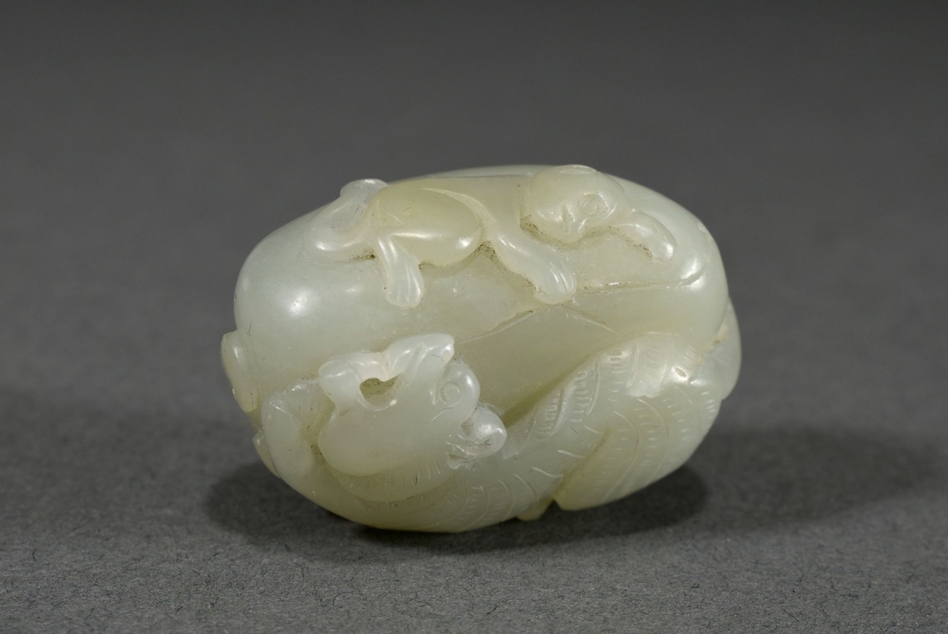 Fine celadon jade toggle "Tiger and monkey on rocks", China, 3.7x2.5x1.9cm