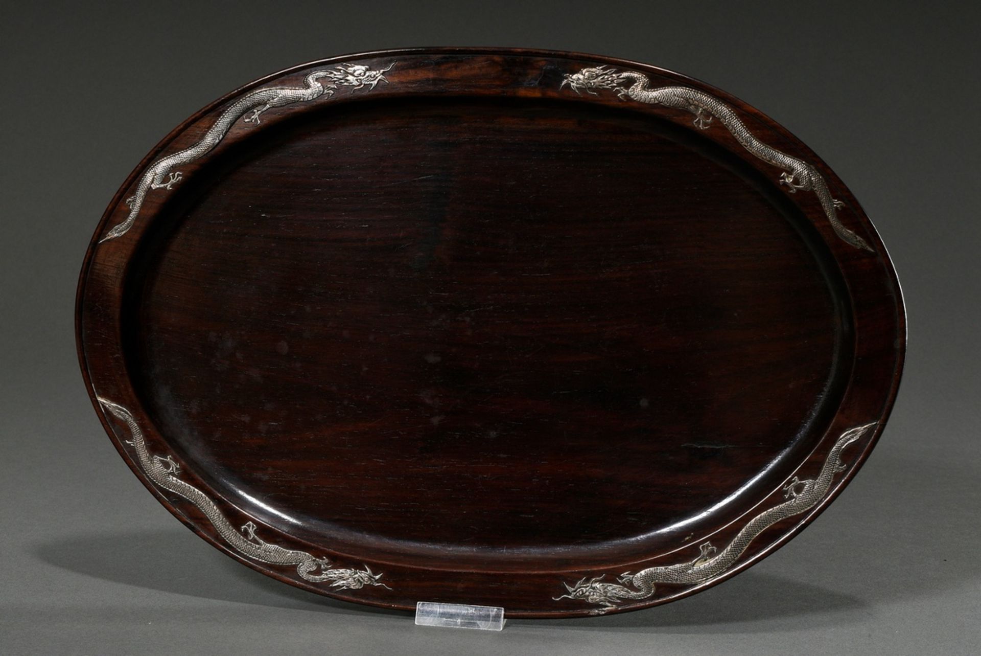 Oval blackwood tray with four silver relief decorations "dragons" on the rim, China circa 1900/1920