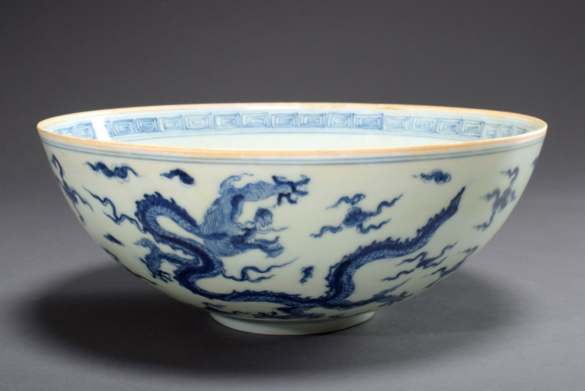 Thin-walled Chinese porcelain bowl with blue painting decor "Cloud Dragon" and "Baku", at the botto