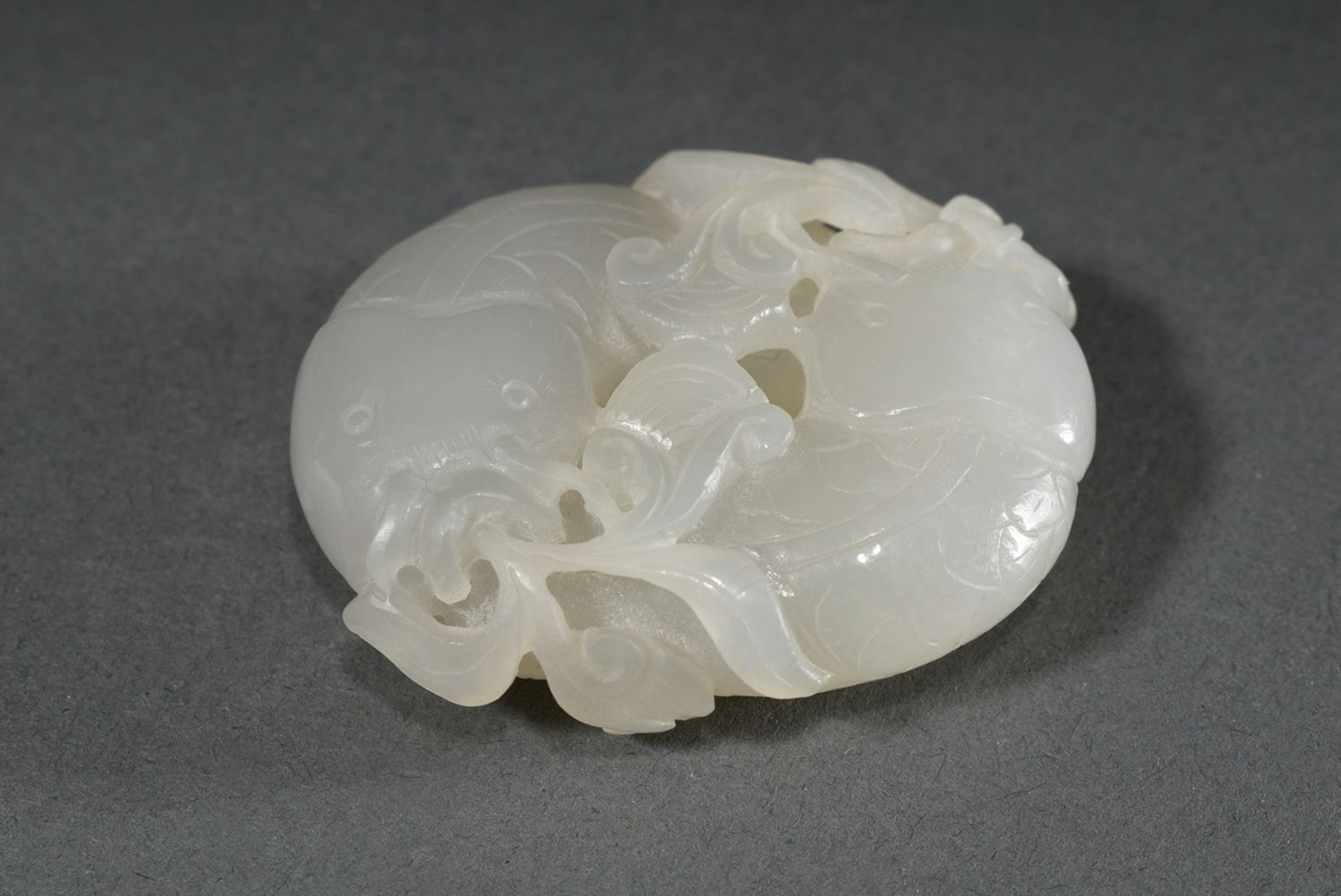 Fine light jade toggle "Two catfish and plants", China, Qing period, wooden stand, 5.3x4.2x1.5cm - Image 2 of 4
