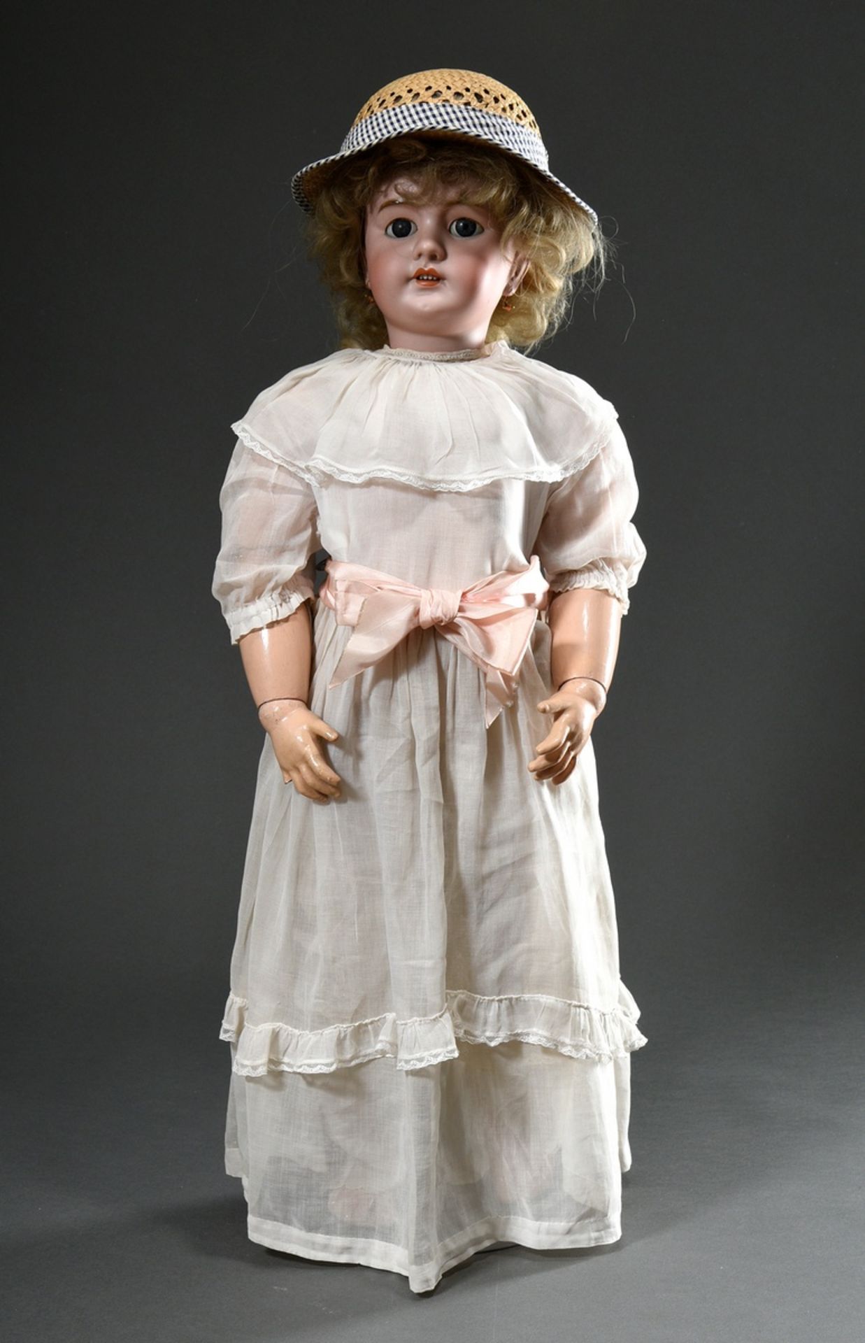 Large doll with bisque porcelain crank head, blue sleeping eyes, open mouth with upper row of teeth