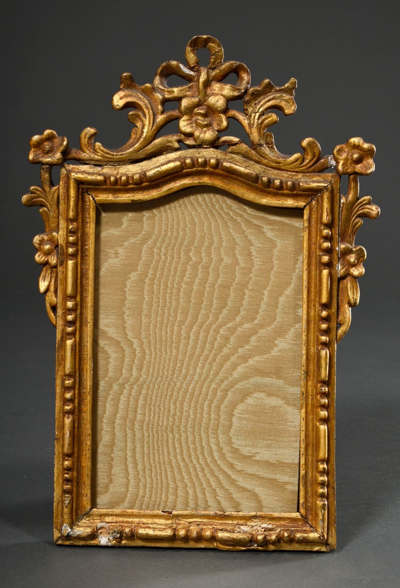 Small baroque frame with floral openwork crowning and beaded rim, wood carved and gilded, FM 19x13c