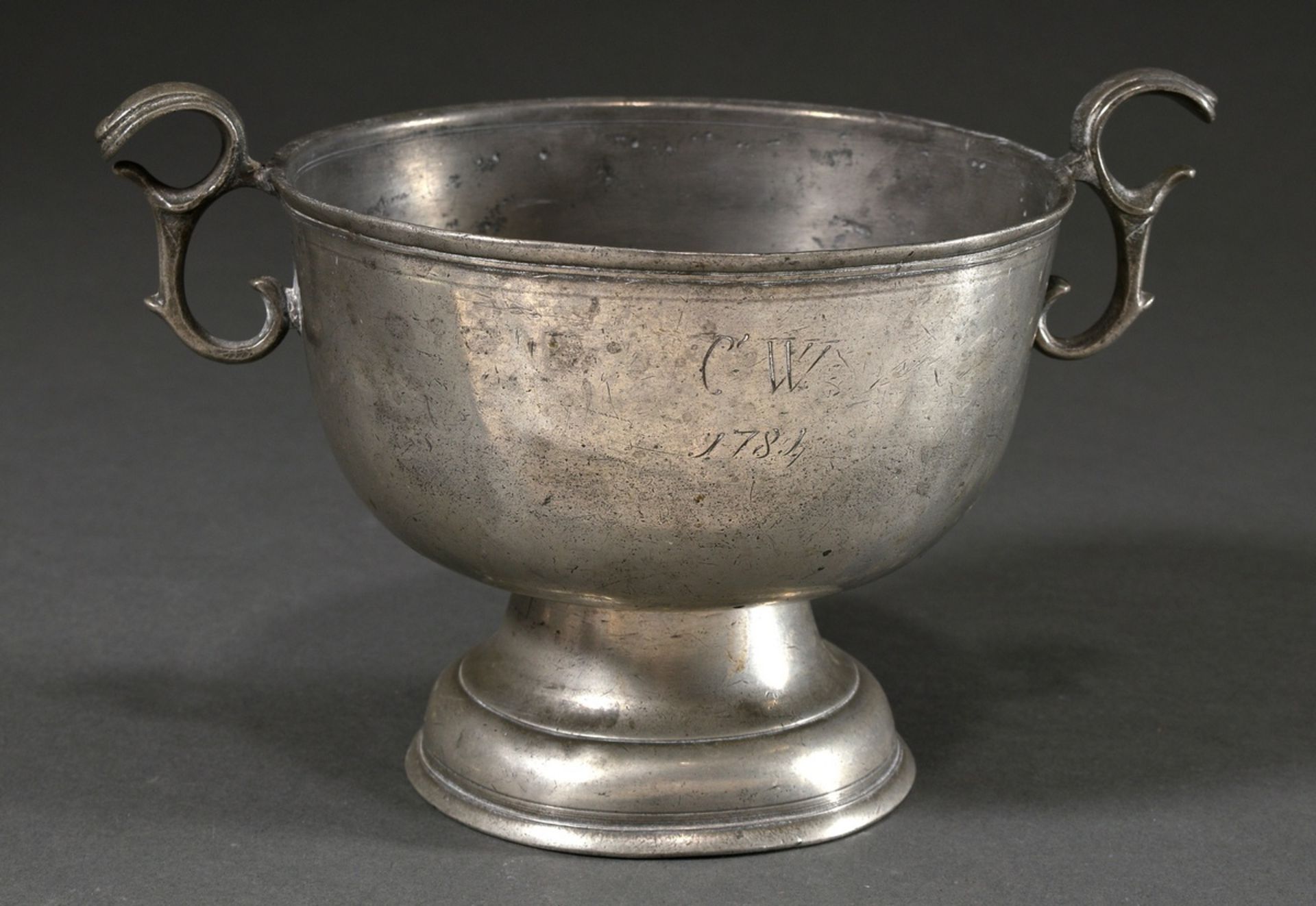 North German pewter bowl with handle on round foot with monogram engraving "C.W. 1784", probably fo