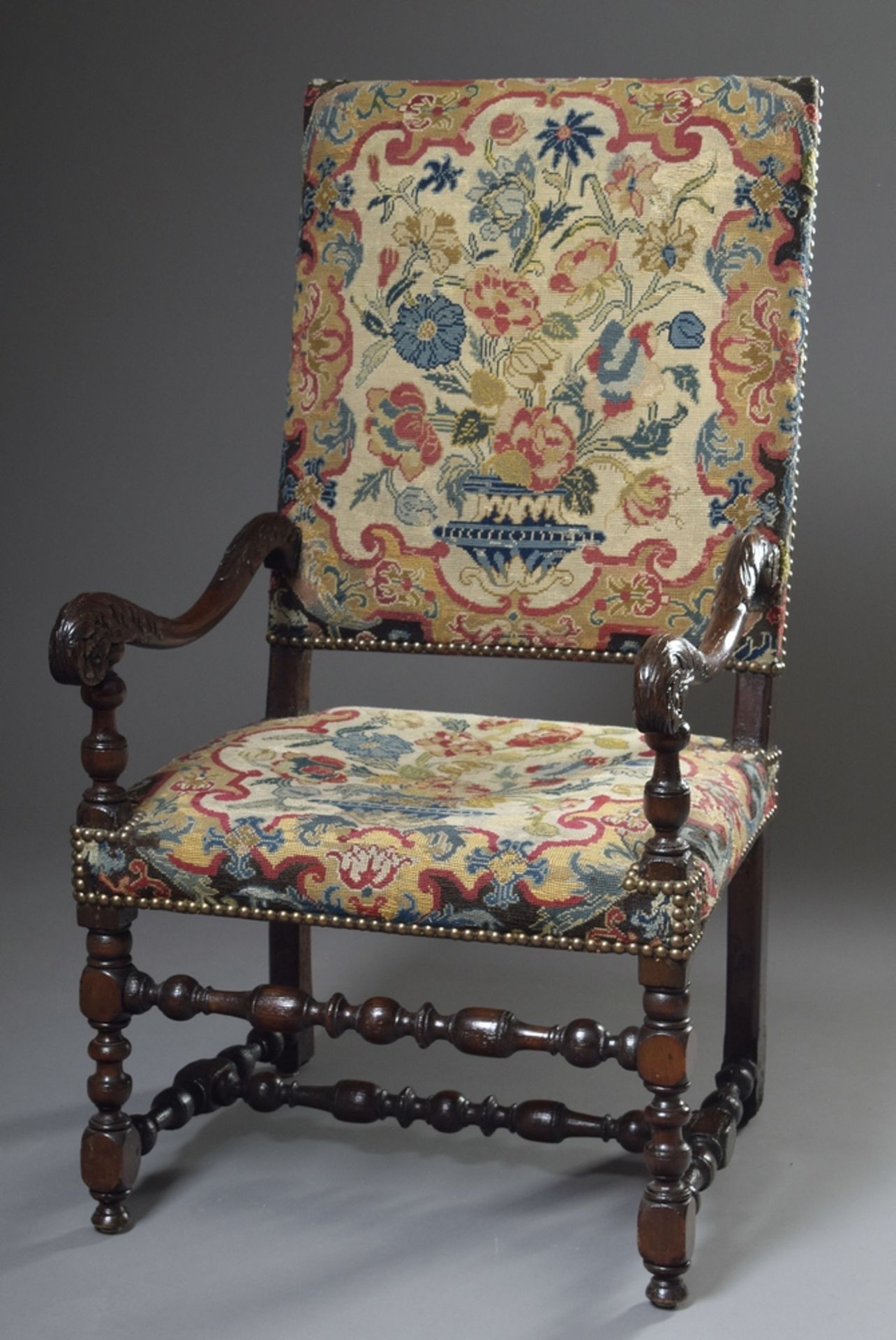 Baroque armchair with floral carved and turned frame, straight backrest and fine embroidered uphols