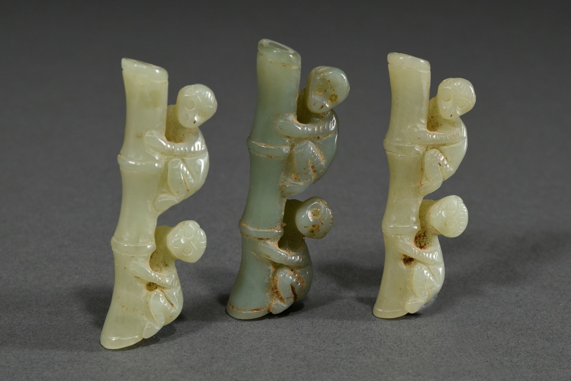 3 Various light green jade carvings: "Two monkeys on bamboo", China, l. 6cm