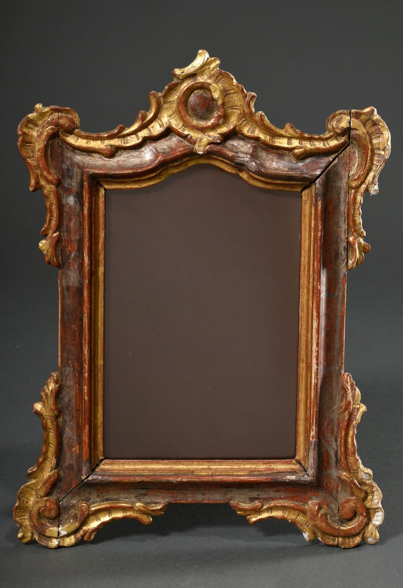 Baroque frame with rocaille decoration at the crown and corners, carved wood, silver and gold paint