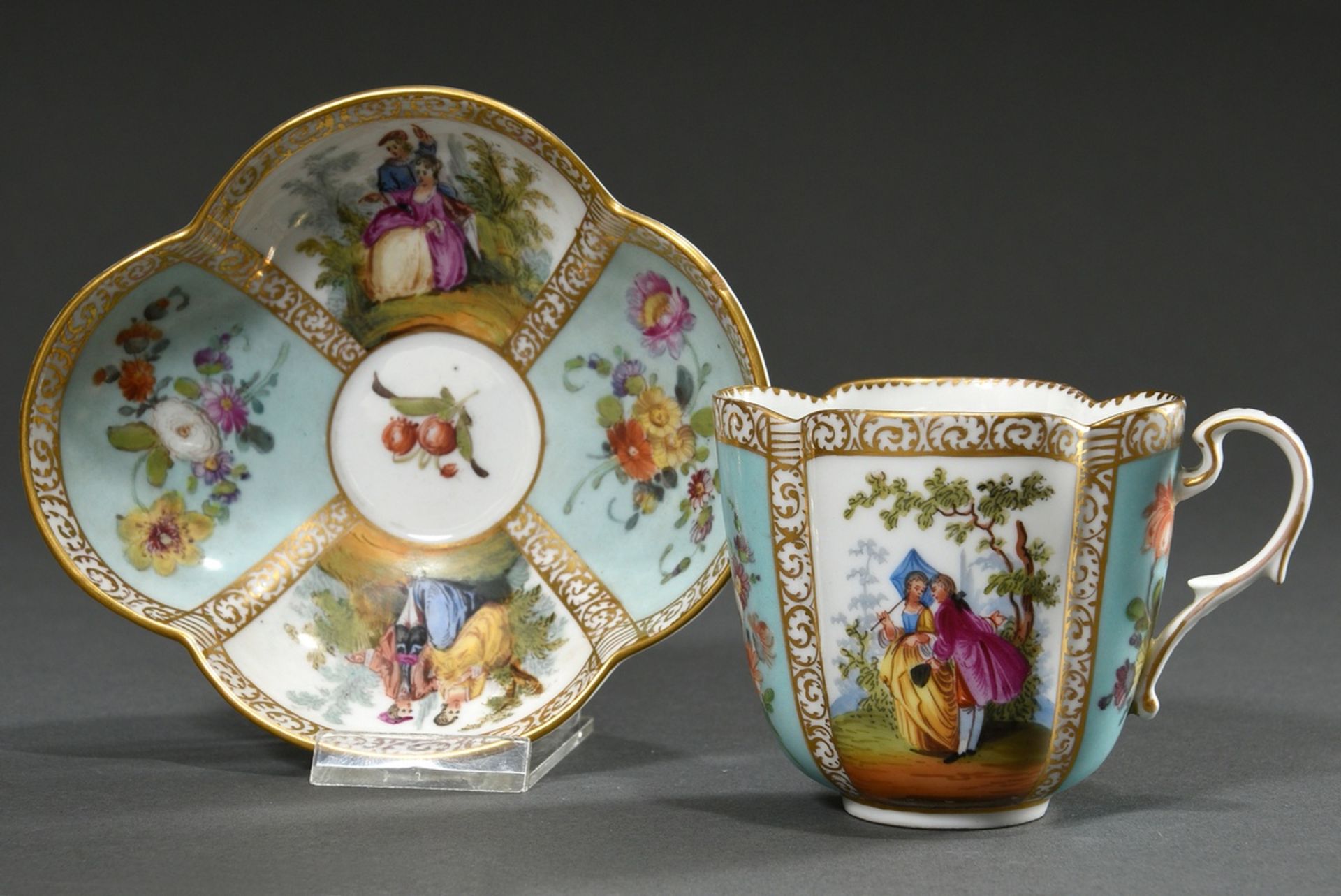 A four-piece porcelain cup/saucer with polychrome painting "Lovers" and "Blossoms" on a turquoise b