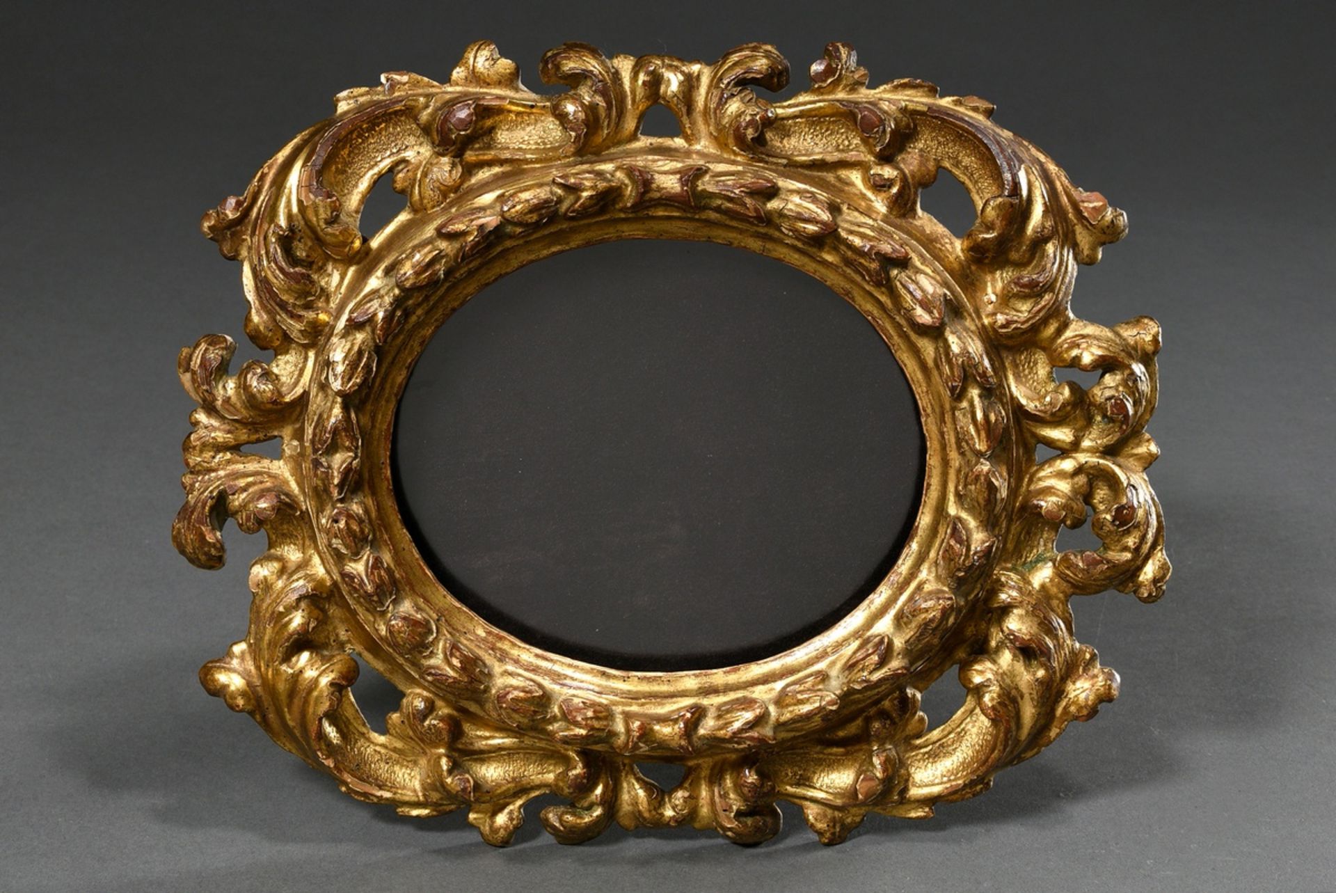 Oval baroque frame with detailed laurel and vine decoration, wood carved and gilded, 18th century,