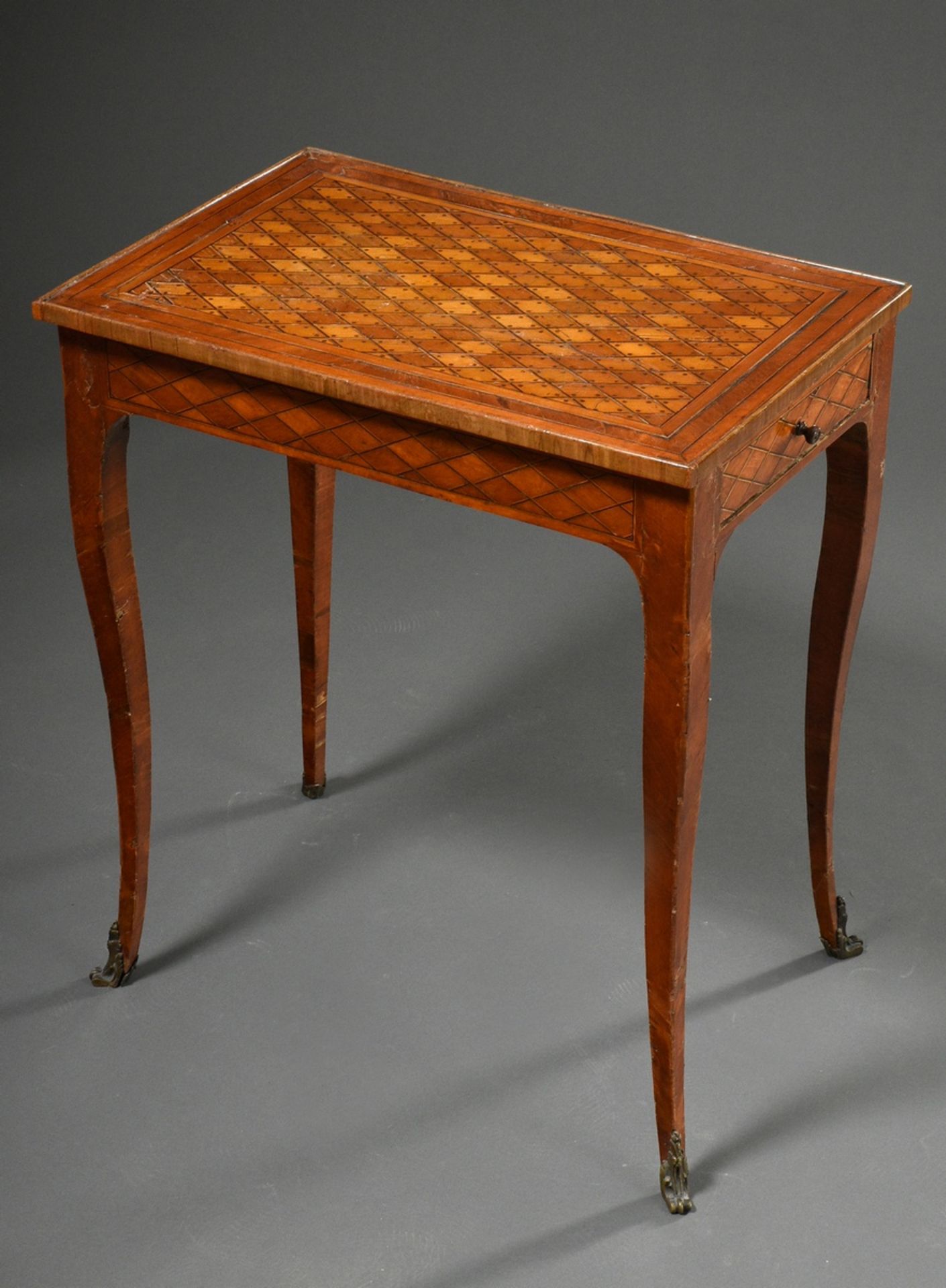 Ornamental Louis XV table with diamond and dot inlays on curved legs with ornamented bronze shoes, 