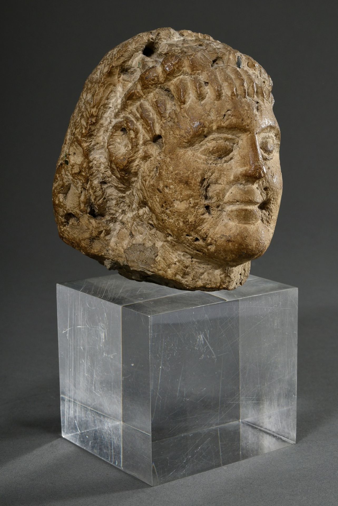 Limestone fragment "Head of a man with wig", reworked on the back, probably from half relief, h. 14