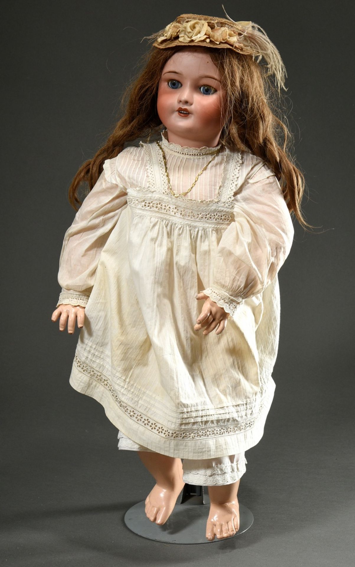 Unis France doll with bisque porcelain crank head, blue sleeping eyes, open mouth with upper row of