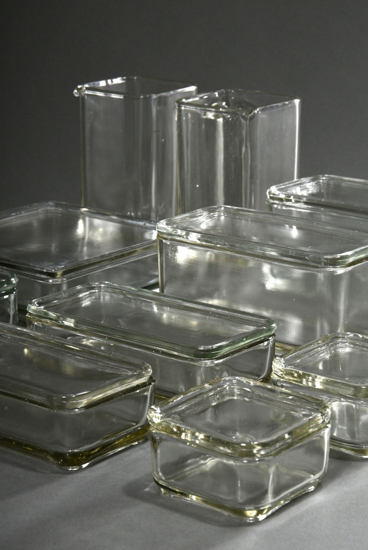 12 Stackable storage jars from the "Kubus-Geschirr", 7 with lid, colourless pressed glass, design: