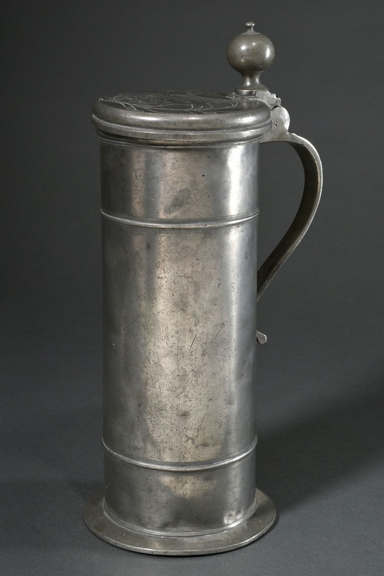 Tall pewter lidded tankard with floral engraved decoration and owner's inscription "Asmus Hinrich M