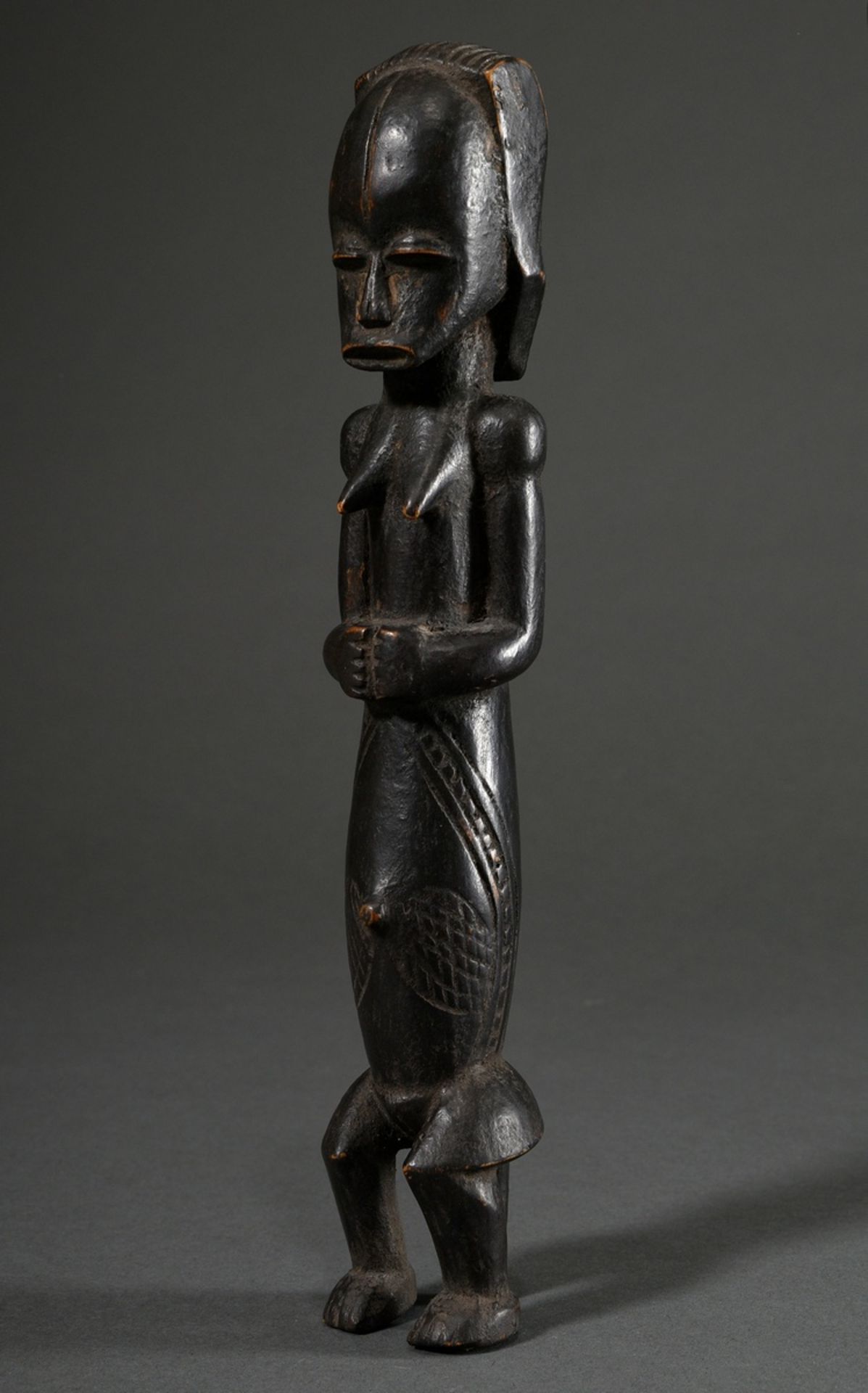 Small female African ancestor figure with scarifications, wood carved and dark stained, probably Fa