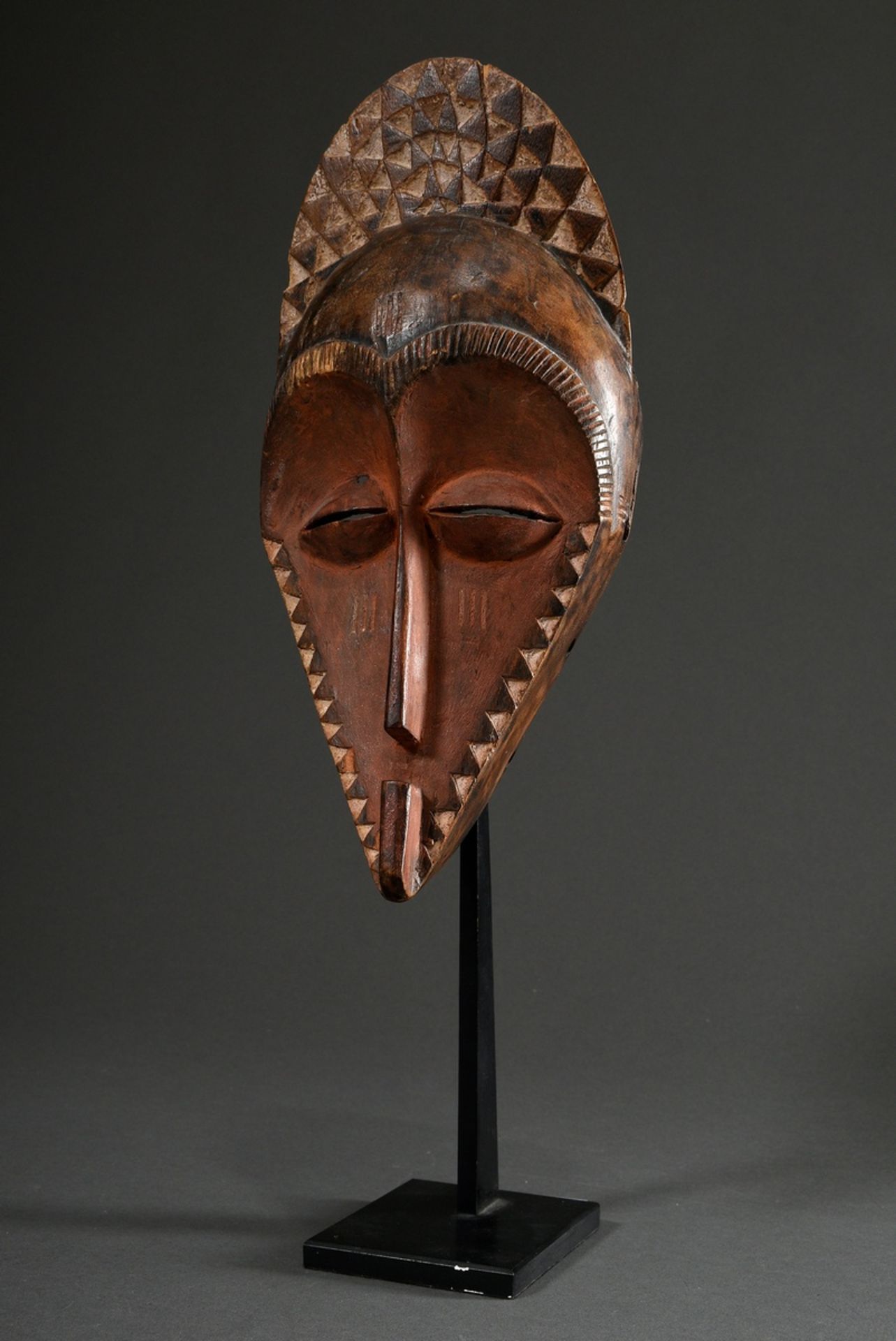 Pende mask with fan-shaped coiffure attachment and geometrical decoration, carved wood, darkly pain