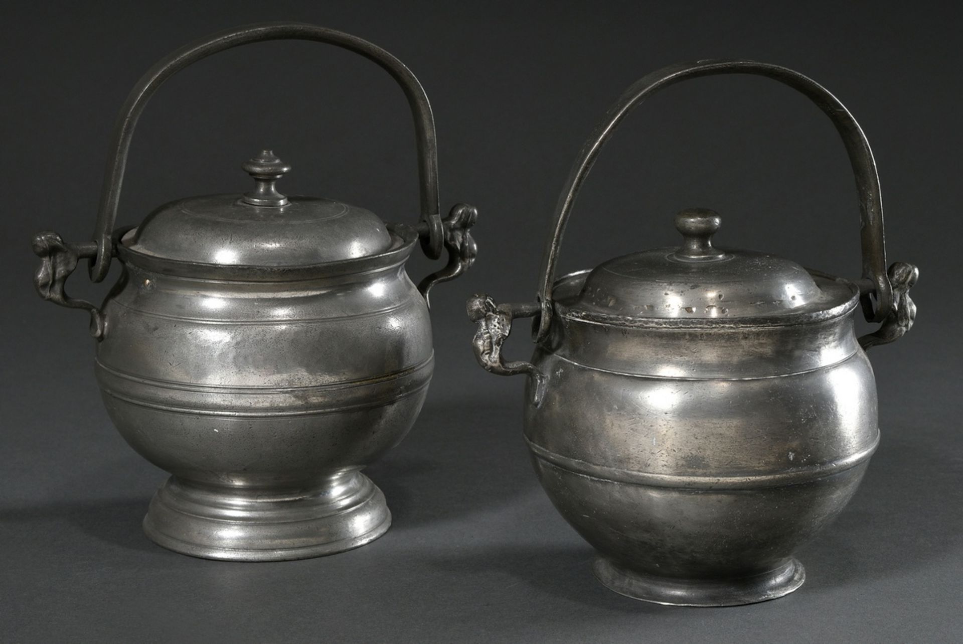 2 Various Lübeck pewter hanging pots with figural handles (food carriers), MZ: Johann Anton Kupffer