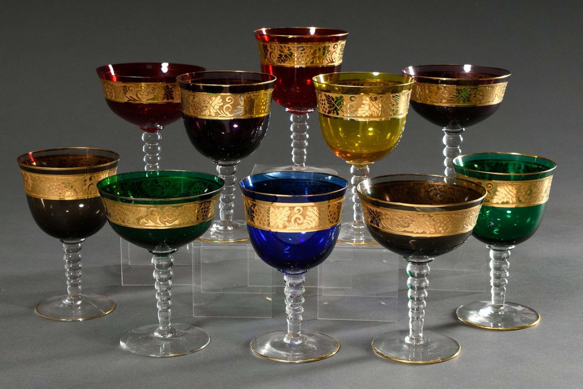 10 Various different coloured glasses with etched and gilded "Weinlaub" frieze over conical ball st