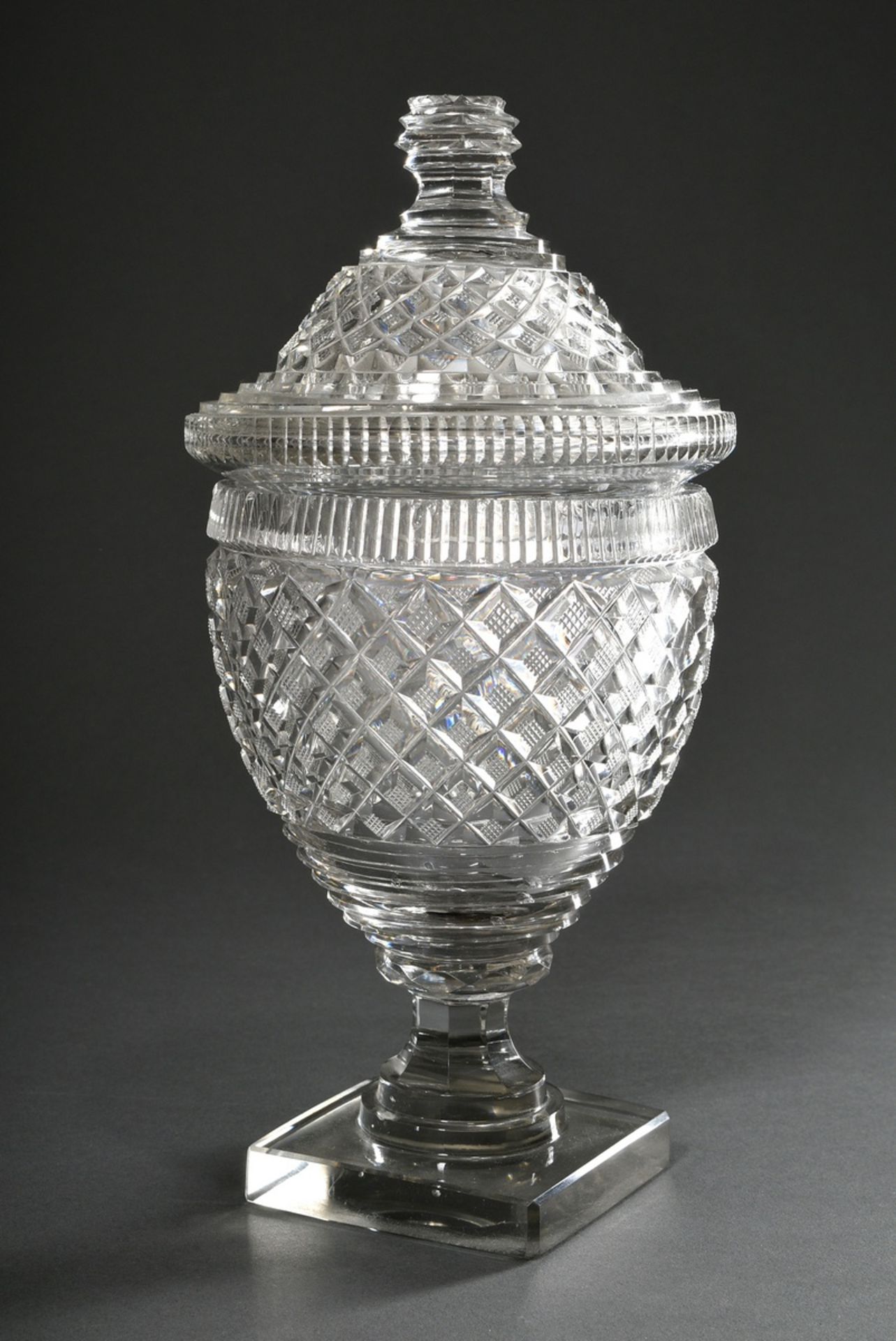 Crystal lidded goblet with rich cut on square base, 19th c., h. 30cm, chipped
