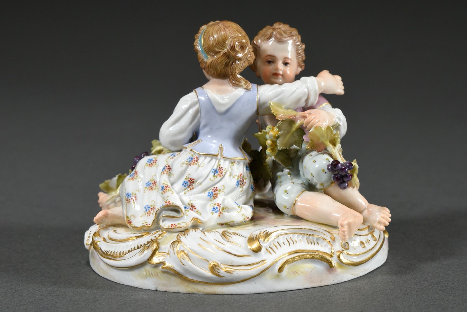 Small Meissen group "Two Children with Grapes", a boy and a girl sitting on an oval rocaille base f - Image 2 of 7