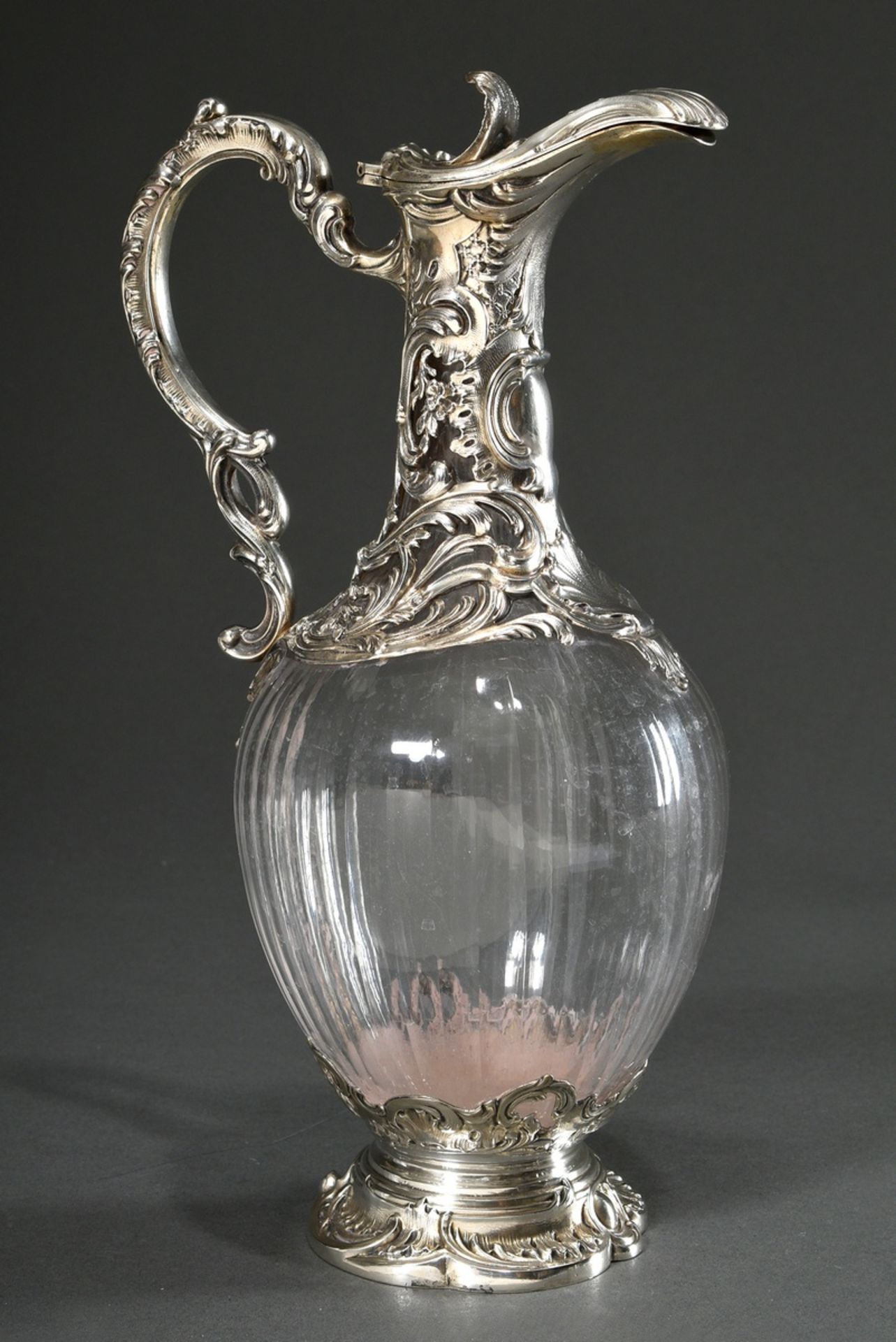 Elegant cupboard jug with faceted body and floral silver mounting in neo-rococo style on neck and f