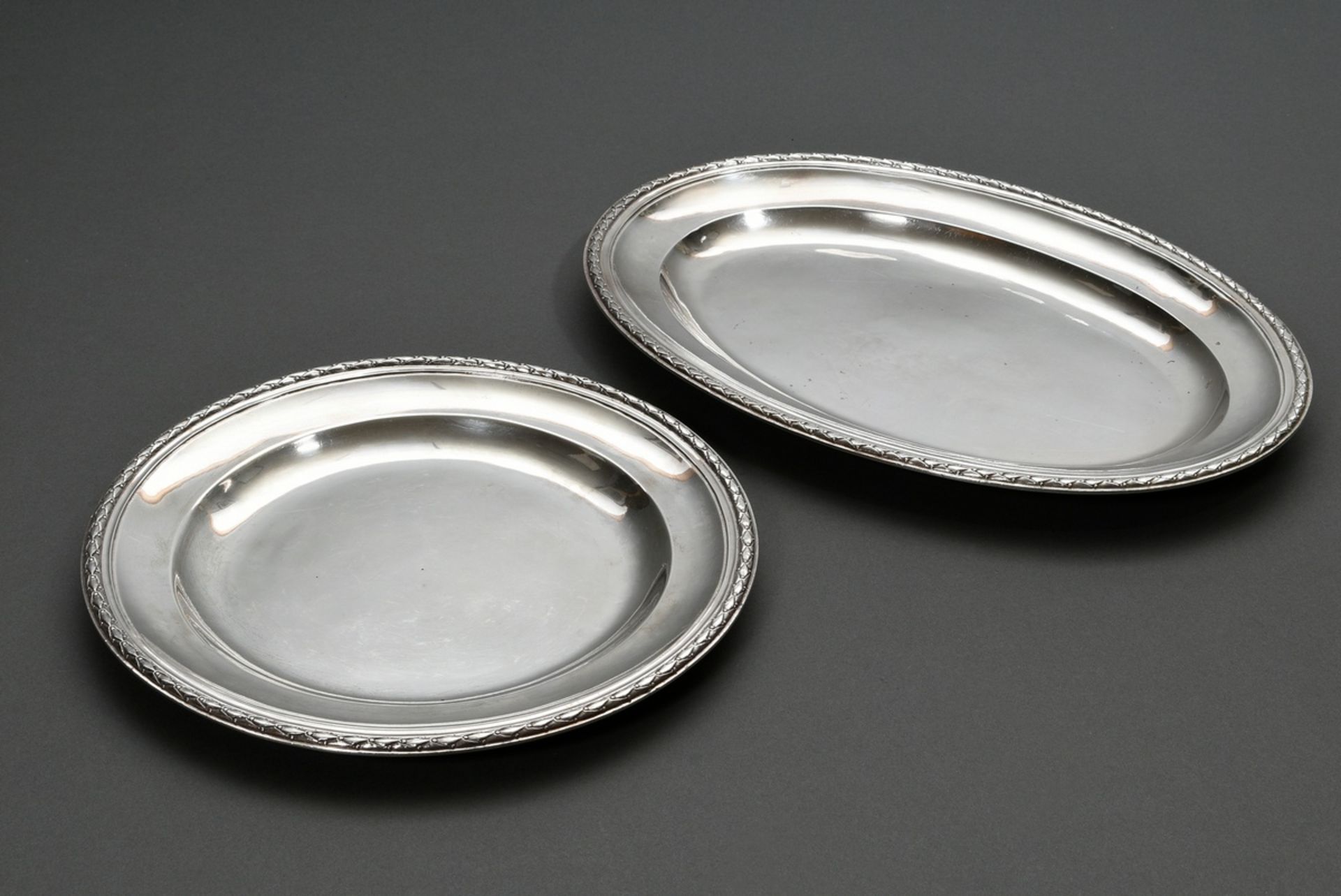 2 Various plates with plastic lorbeer border: round (951g, Ø 30,2cm, Paris 1787) and oval (1149g, 2