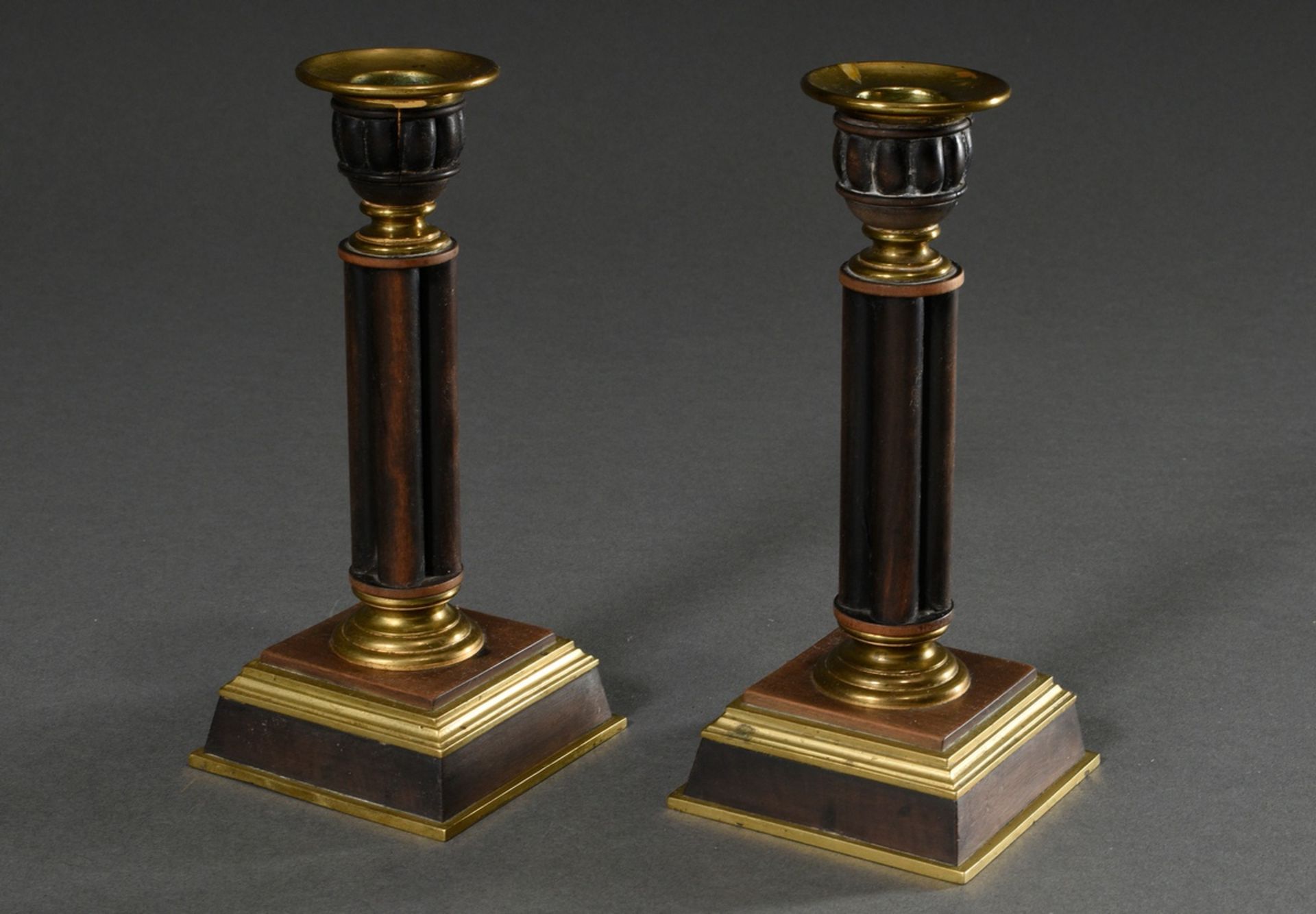 Pair of historicism candlesticks with carved spouts, shafts and feet in brass mounts, probably Engl