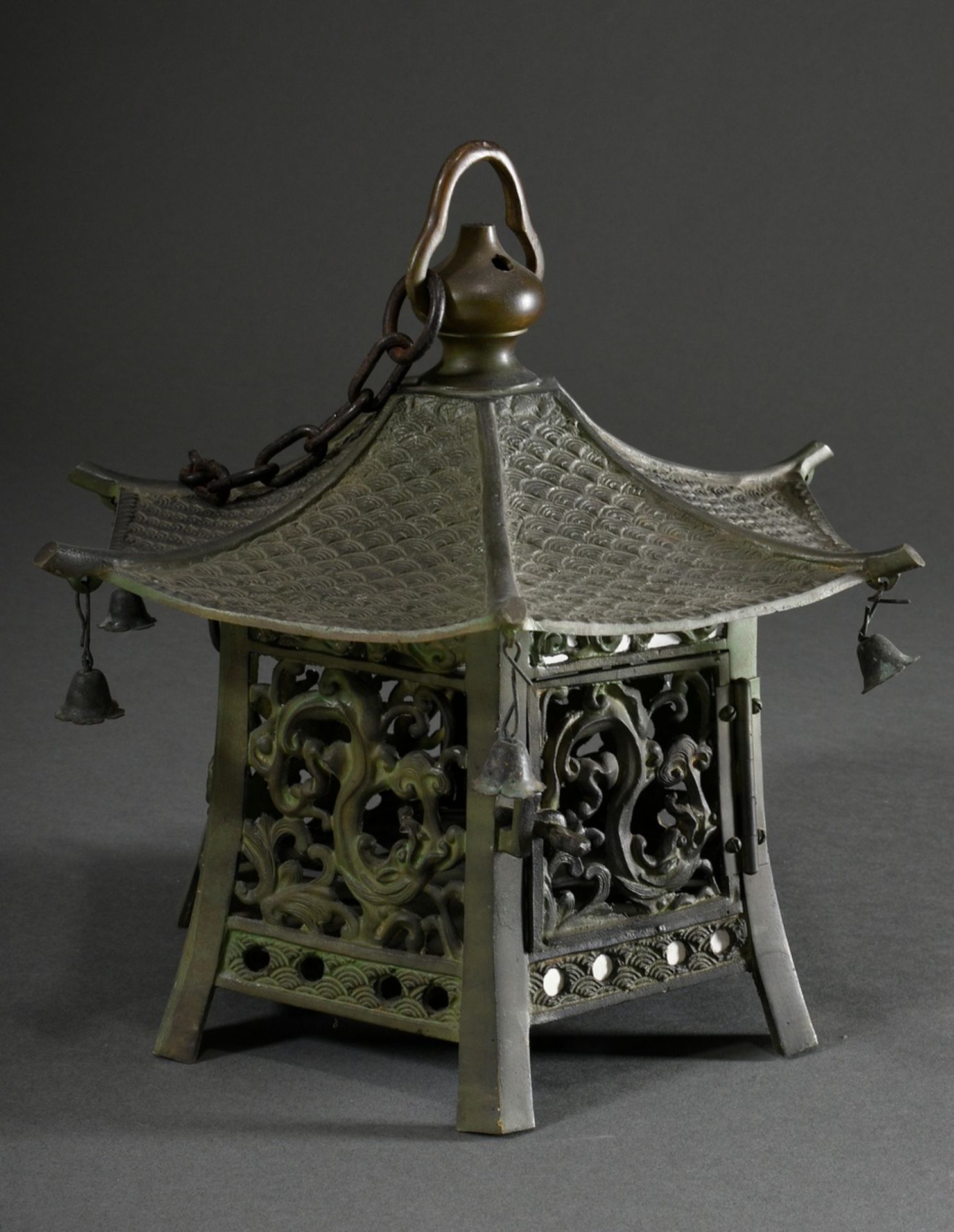 Small hexagonal lantern in the shape of a pagoda with movable bells at the tops of the roofs and "d