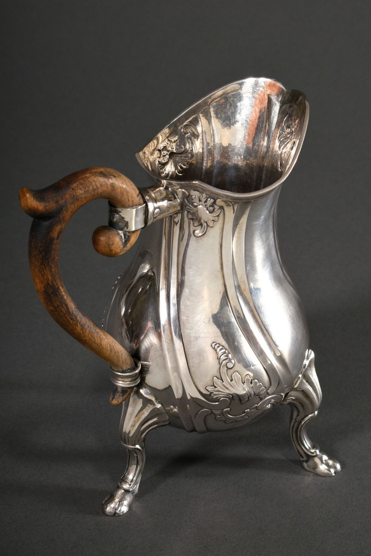 Elegant milk jug with curved wooden handle on paw feet with rocaille reliefs over curved features,  - Image 2 of 3