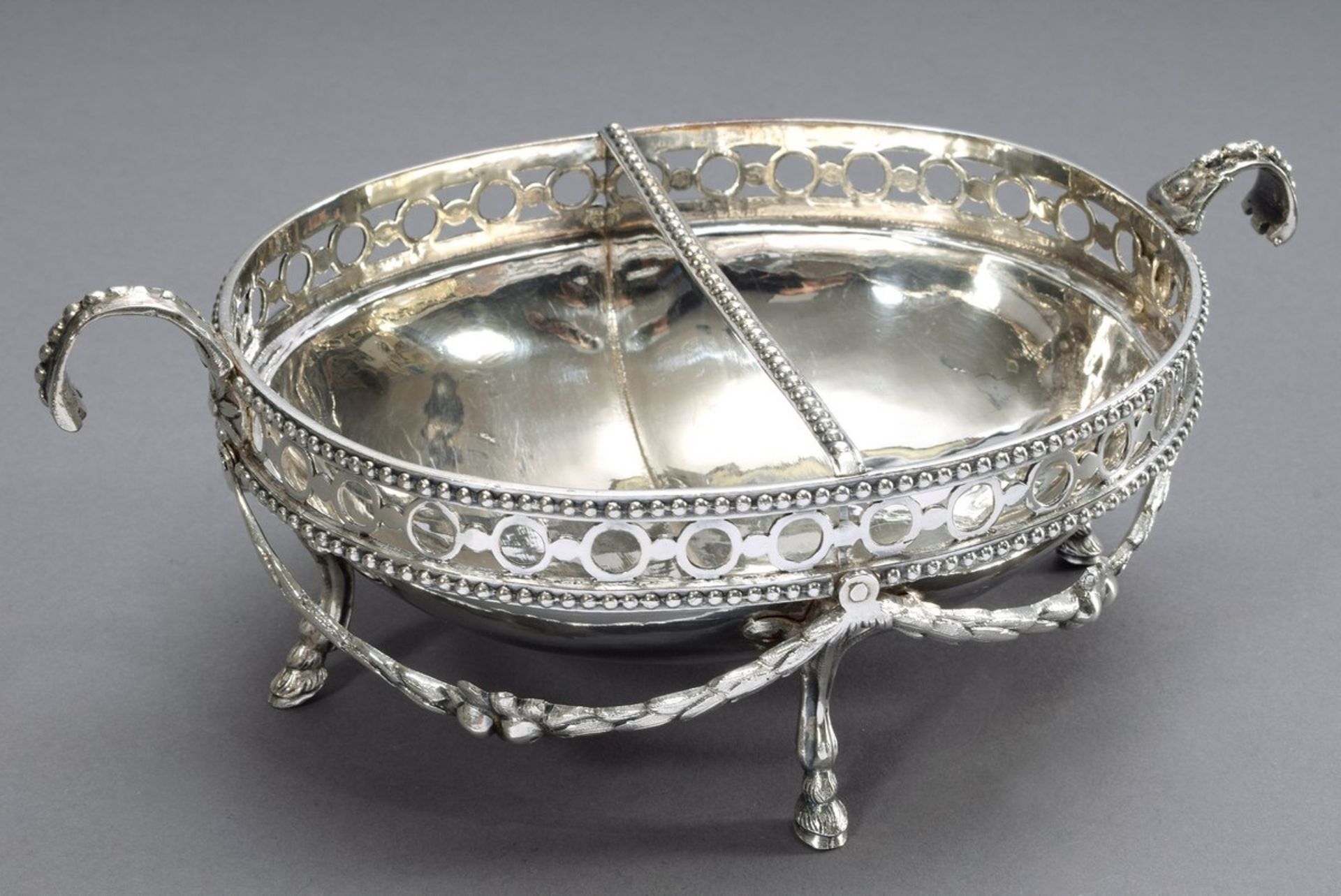 Oval classicistic offering bowl on goat feet with central separation and openworked rim as well as 