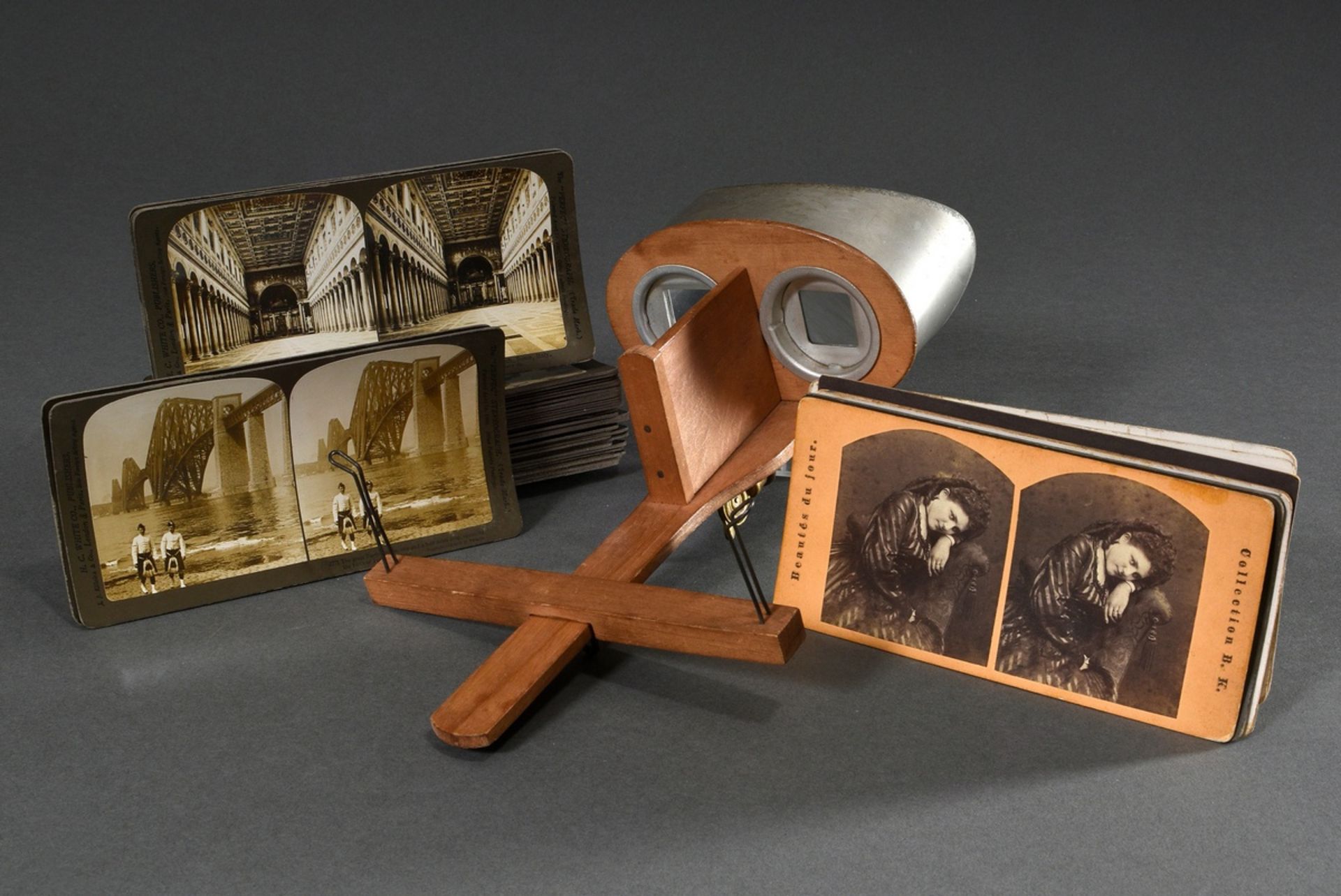 Hand-held stereo viewer with numerous stereo photos, German circa 1900, viewer with retractable han
