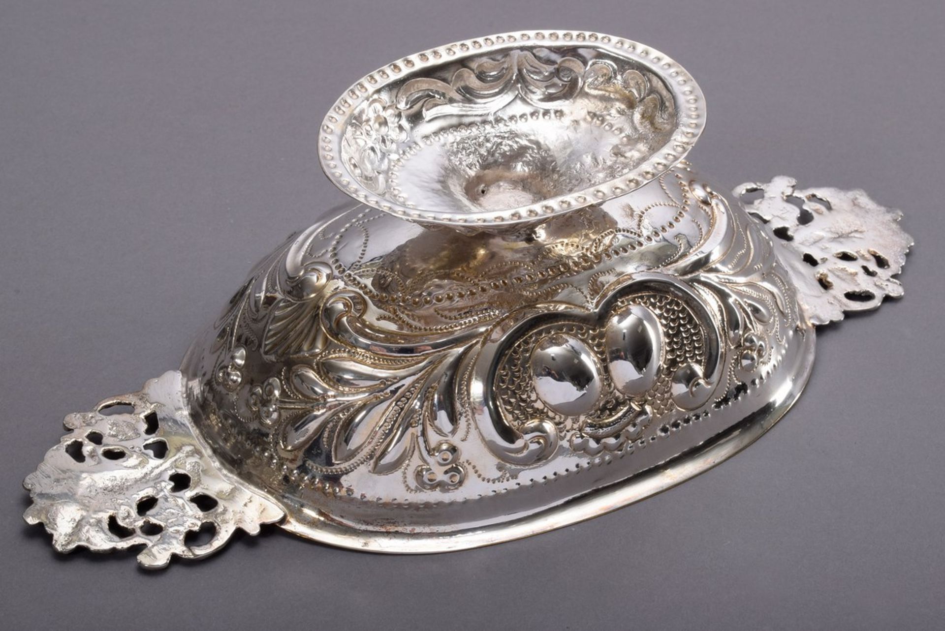 Oval brandy bowl with ornamental embossed wall and plastic handles with figural decoration, at the  - Image 2 of 4
