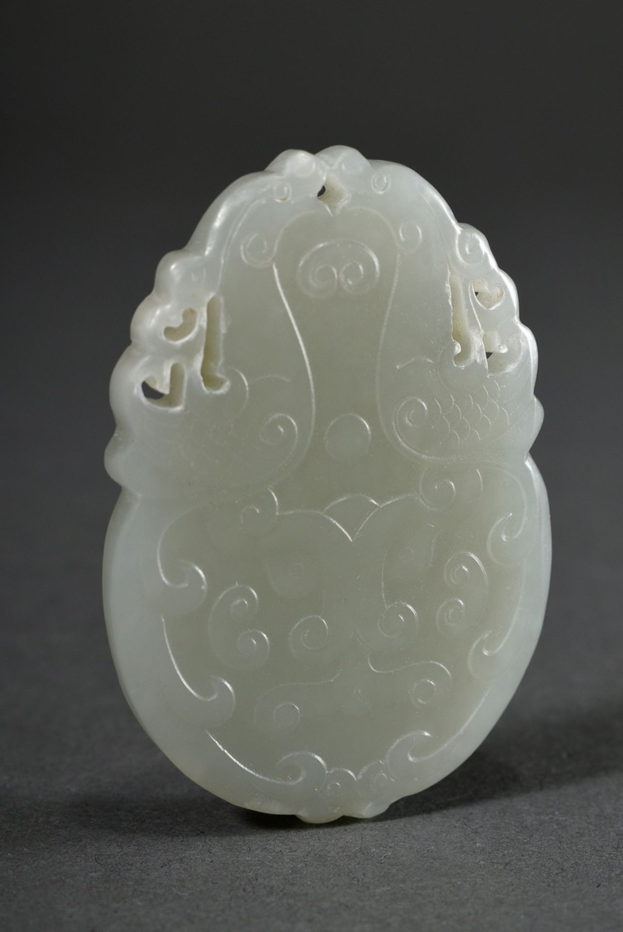 Pale celadon jade tablet pendant, finely cut taotie masks and mythical creatures in bas-relief on b