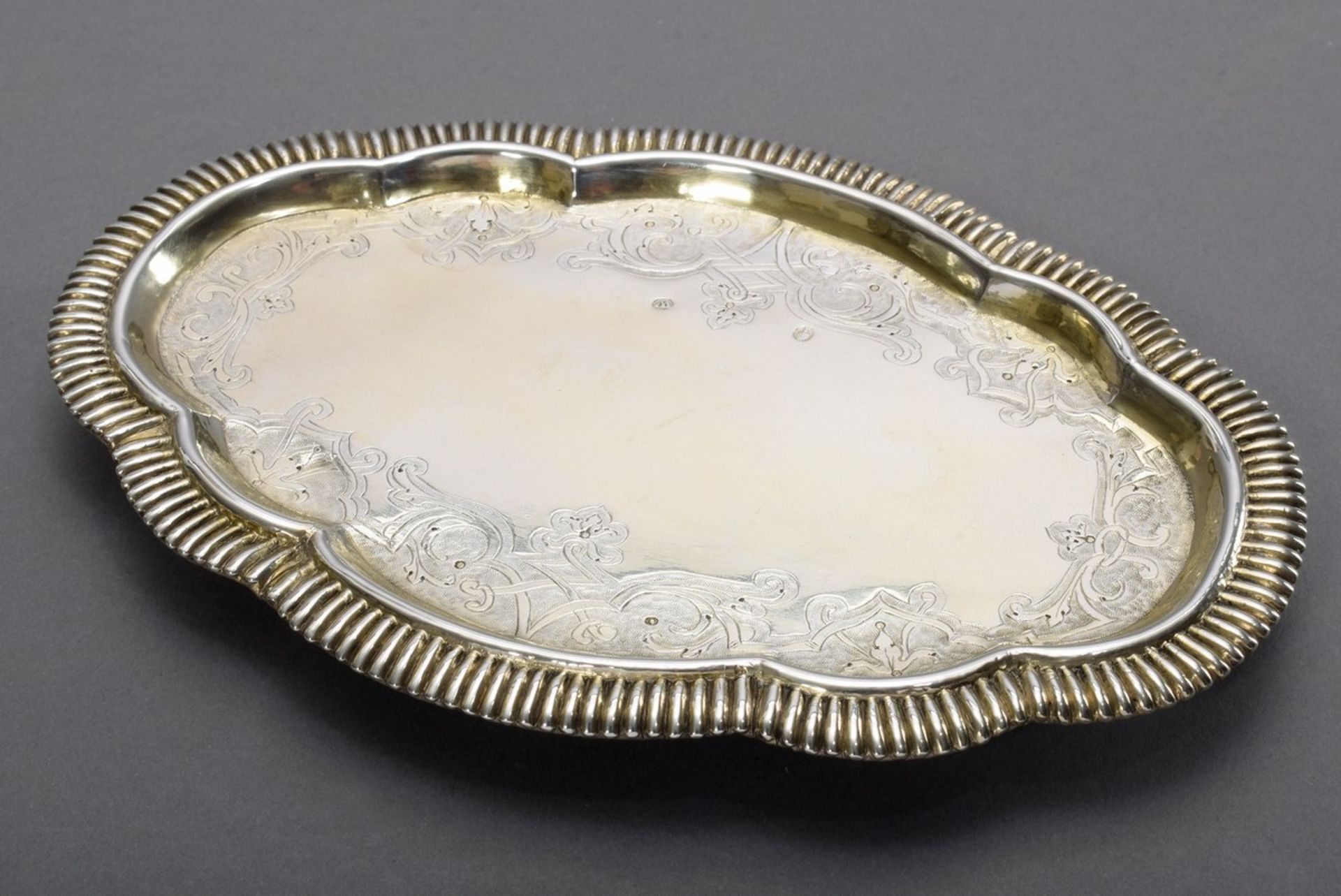 Small Régence tray with curved grooved rim and delicately engraved strapwork on ball feet, the bott