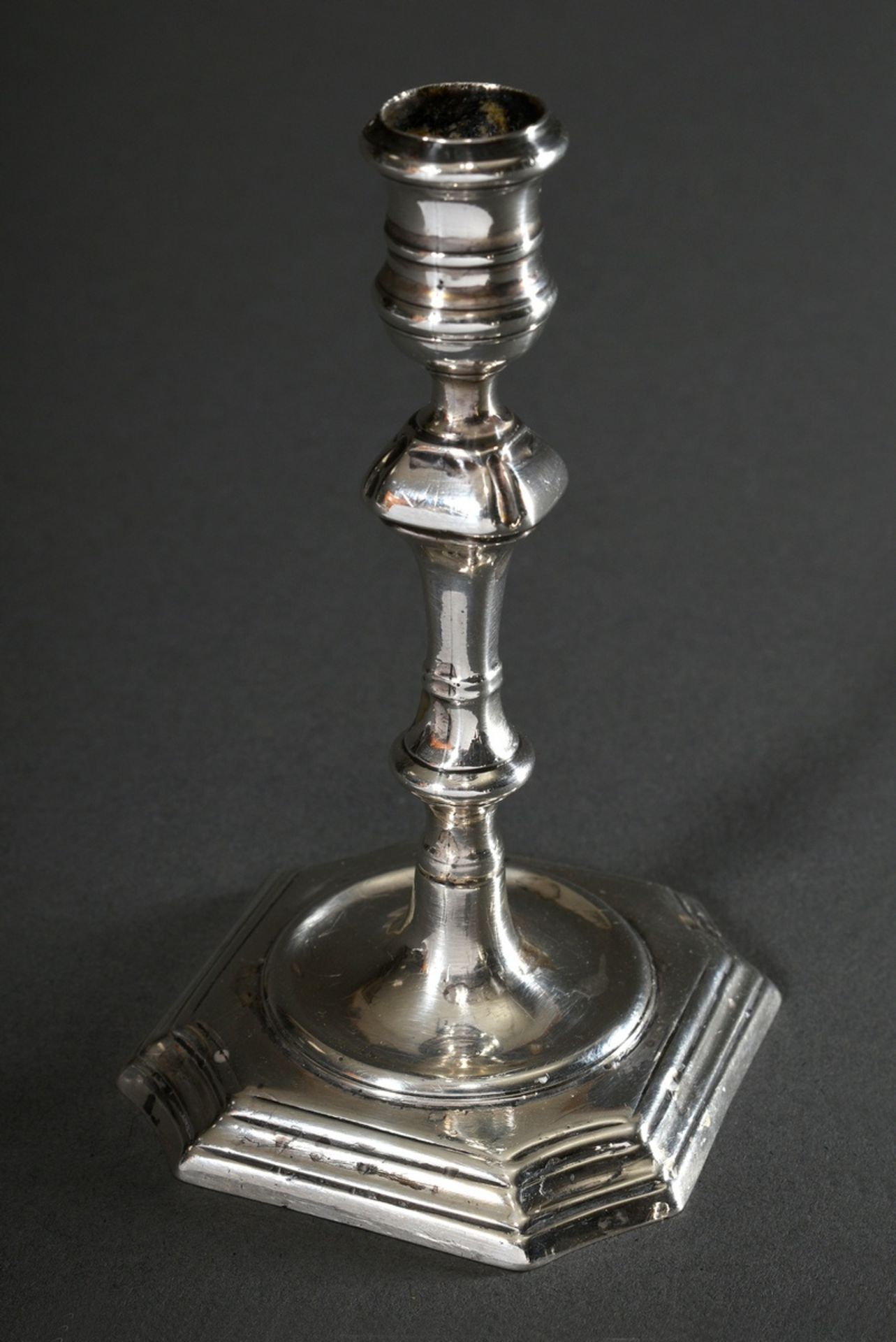 Miniature candlestick of English baroque shape with angular baluster stem on square base with inden