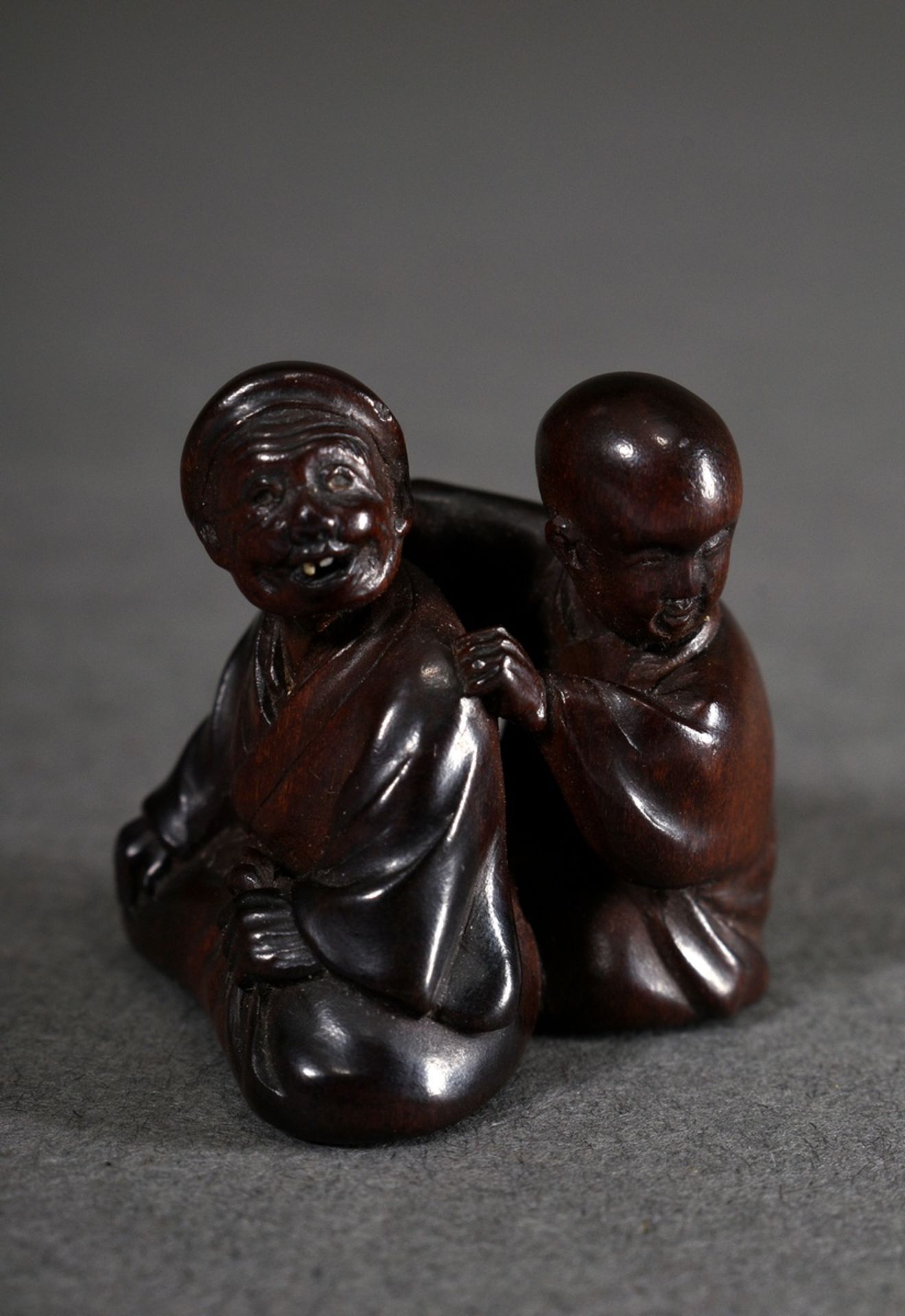 Boxwood netsuke "Masseur with patient", teeth of the patient inlaid in mother-of-pearl, sign.: Miwa