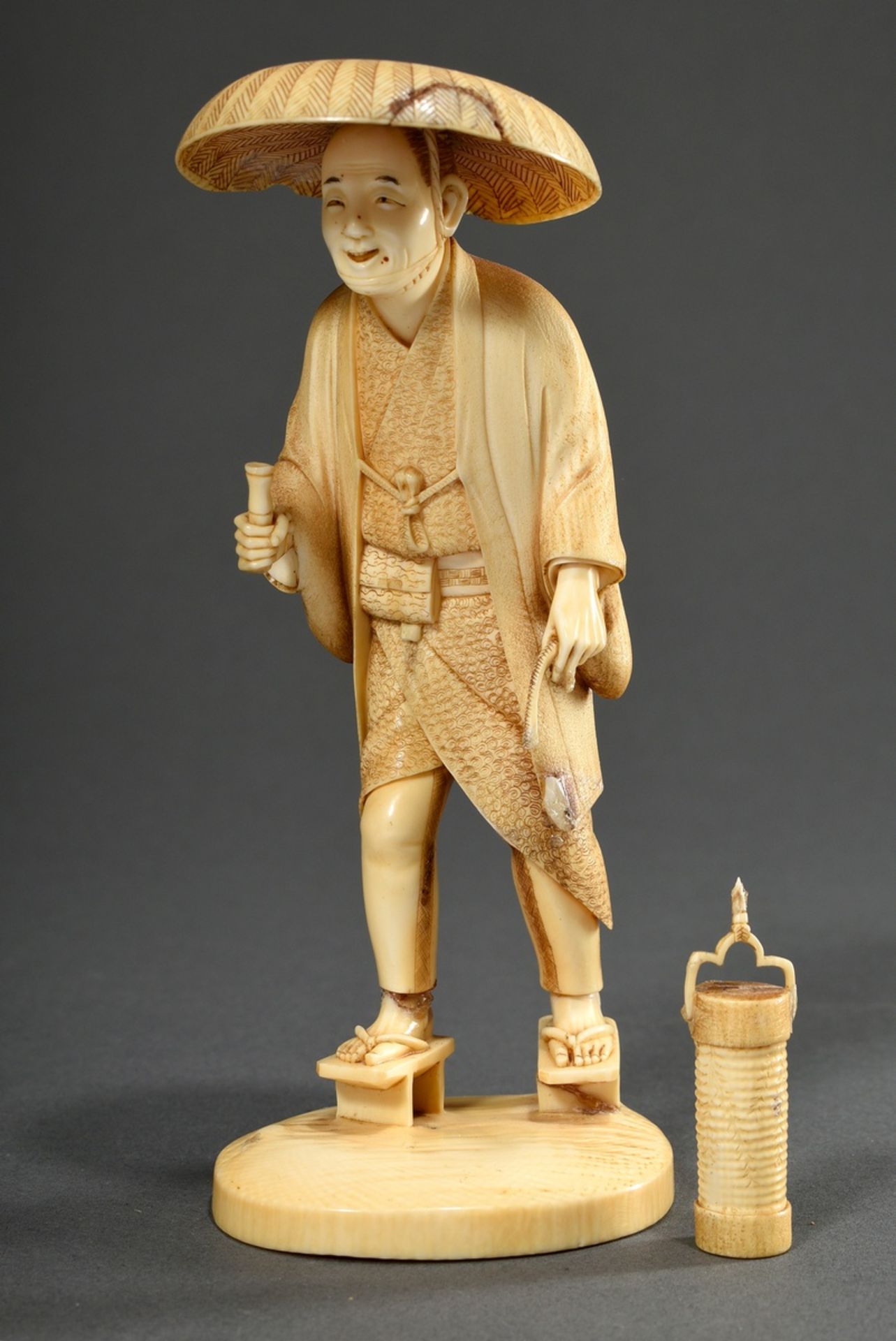 Ishikawa Komei (1852-1913) attributed, Okimono "Man with lantern", ivory carved and fine engraved,