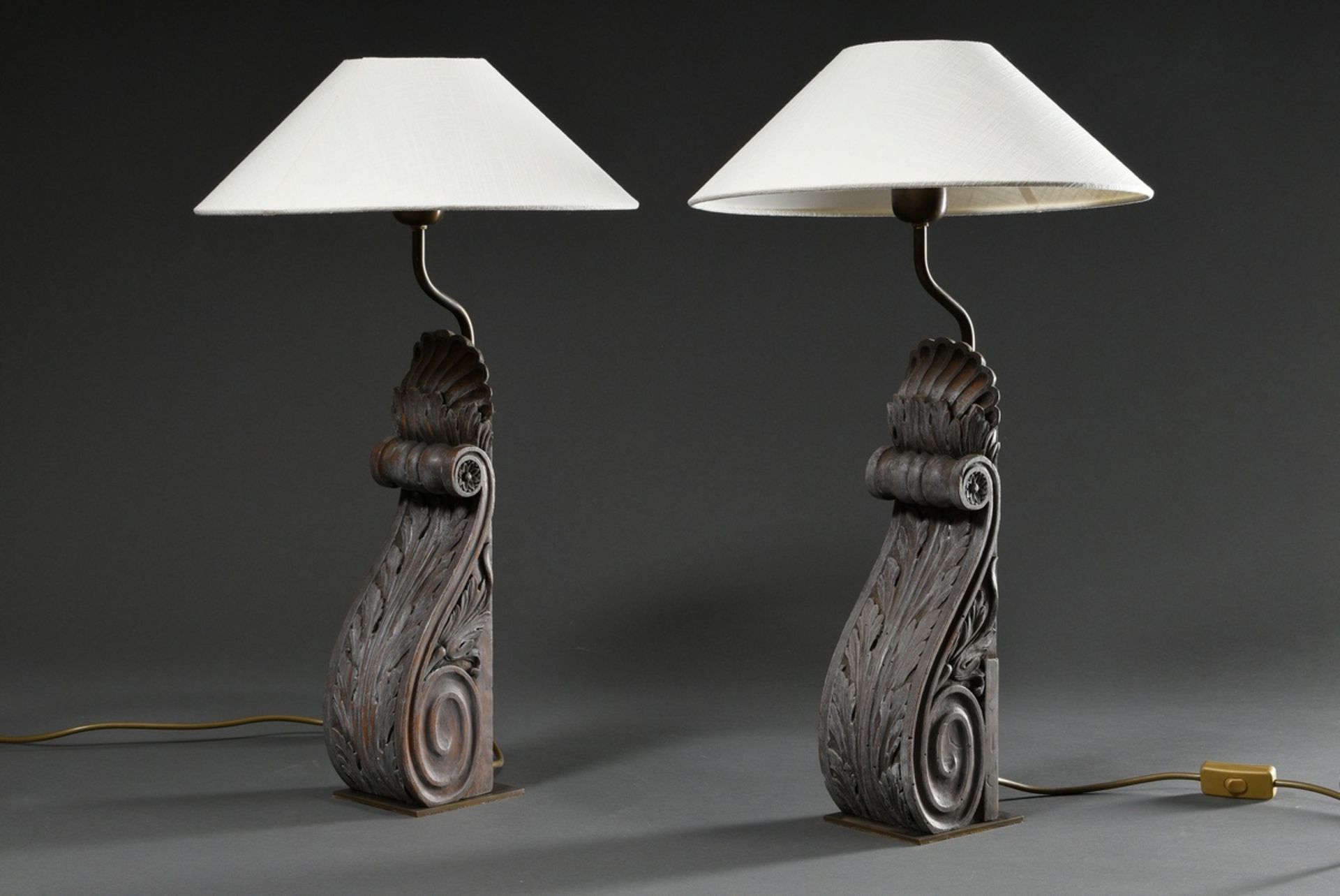 Pair of table lamps in volute form with acanthus leaves, wood carved and grey painted, 20th c., h. 