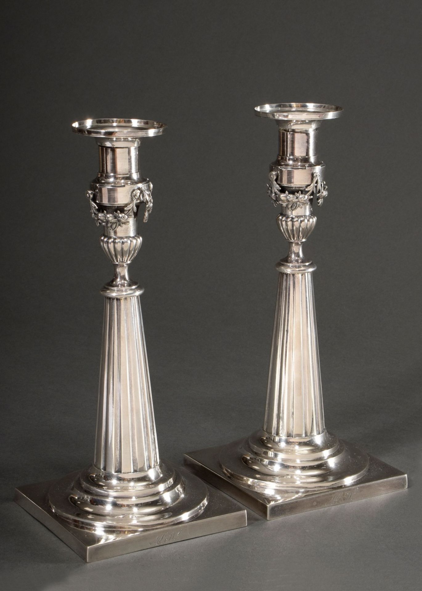 Pair of Augsburg candlesticks with angular base, conical fluted shaft, plastic garlands " Fruits" a
