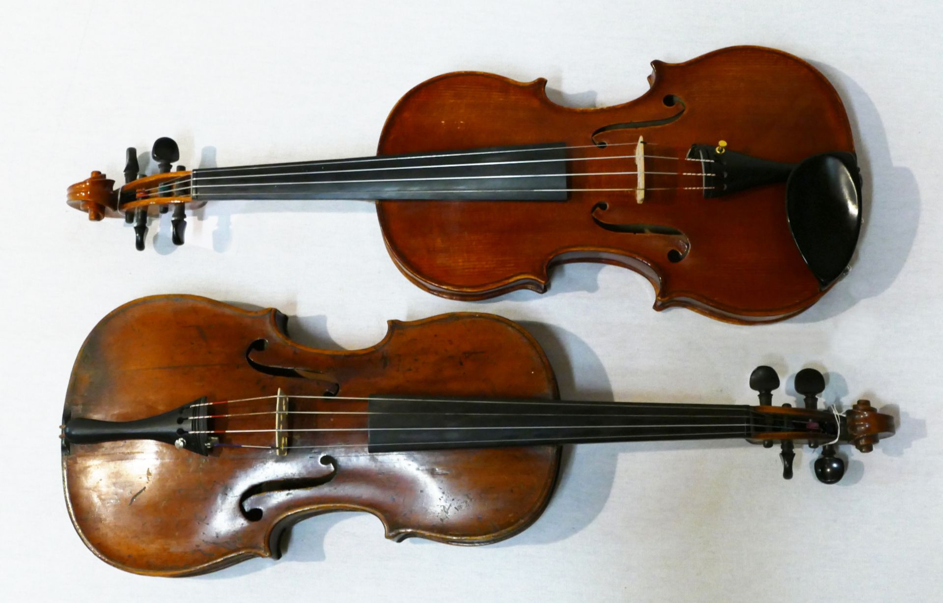 2 Geigen: lt. EL 1x um 1800, je L ca. 60cm, z.T. min. besch. (1x mit ausgewechselter Schnecke, u.a.)