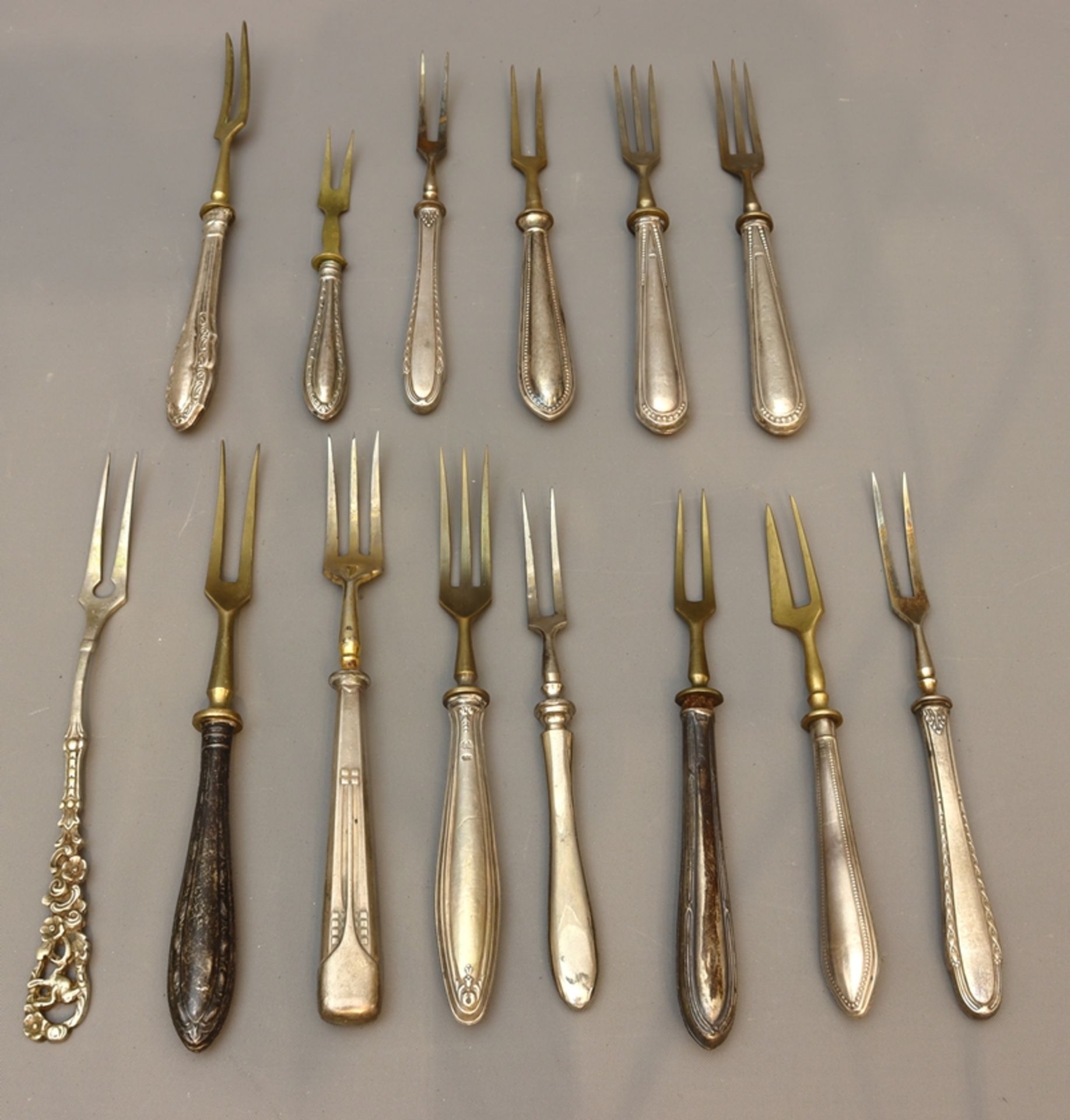 Lot of 14 serving forks of different types, early to mid 20th century, German