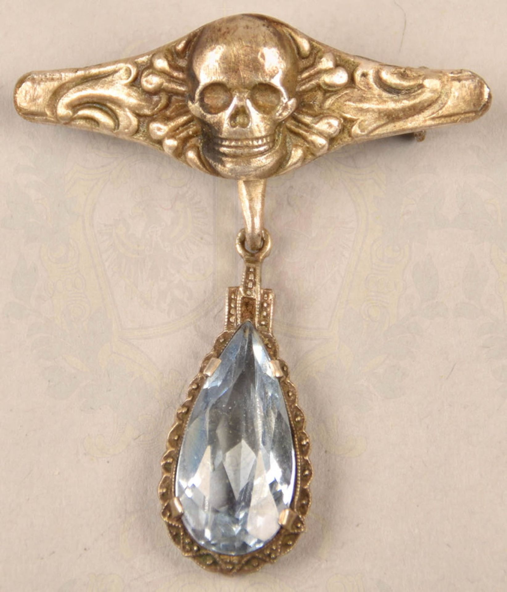 Jewellery brooch with death head and aquamarine pendant