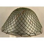 East German steel helmet M1956 with camouflage net