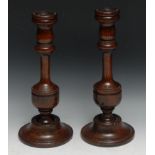 Treen - a pair of 19th century turned oak table candlesticks, baluster pillars, domed bases, 33.