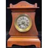 A continental Art Nouveau mahogany mantel clock, arched case worked with tooled scrolling stems,