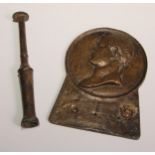 A bronze plaque, cast in relief with a profile portrait of Caesar, 17cm long; a bronze horn or