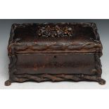 A large Black Forest rectangular bombe shaped table casket, leather clad and carved with rustic