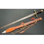 A Sudanese Kaskara sword with double edged blade 855mm in length. Brass crossguard. Leather bound