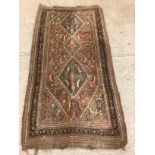 A Middle Eastern rectangular wool rug or carpet, 223cm x 115cm