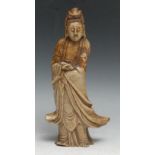 A Chinese soapstone figure, carved as Guanyin, she stands, holding a scroll, 26cm high, 19th century